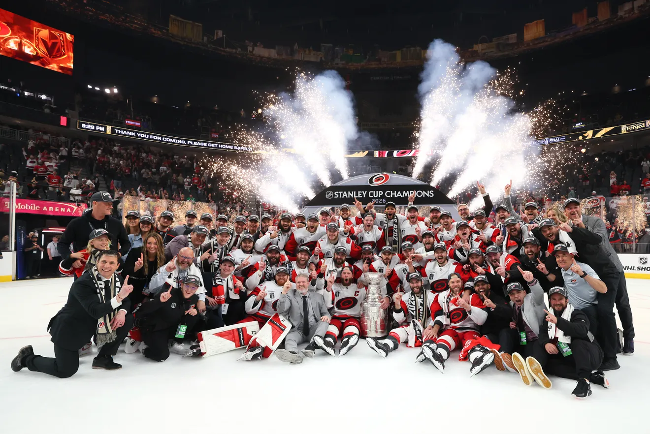 The Carolina Hurricanes pose for a team photo with the Stanley Cup as 2026 champions